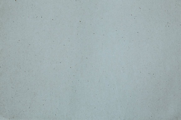 White paper surface with small specks, a texture of recycled paper