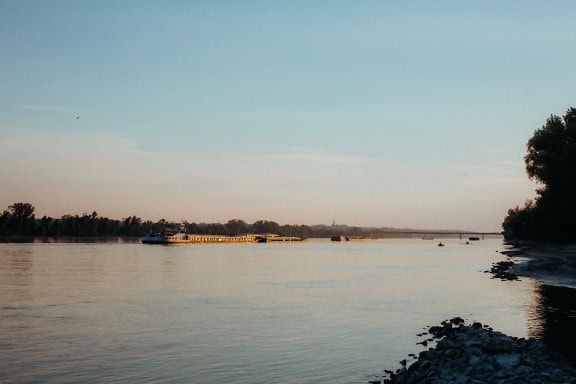 Large barge on a Danube waterway at dusk