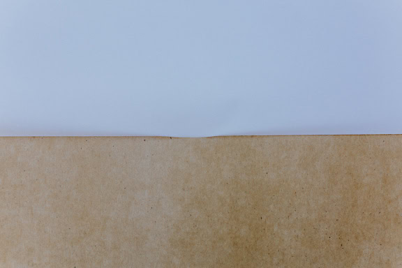 Light brown and white paper, texture of horizontally aligned papers, white in the top half and brown at the bottom