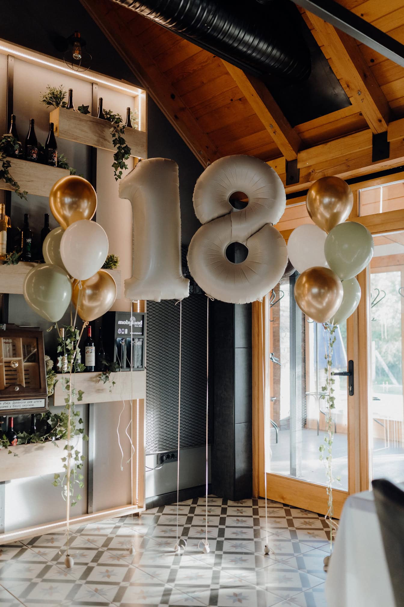 Globos inflados de helio en forma de número dieciocho (18), una decoración en restaurante de vino para la celebración de cumpleaños de una edad adulta