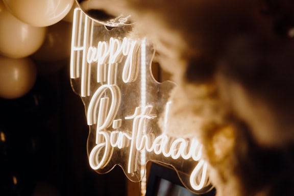 A Happy Birthday white neon sign