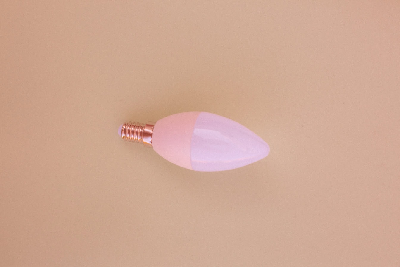 Energy-saving light bulb with a light-emitting diode on a beige background