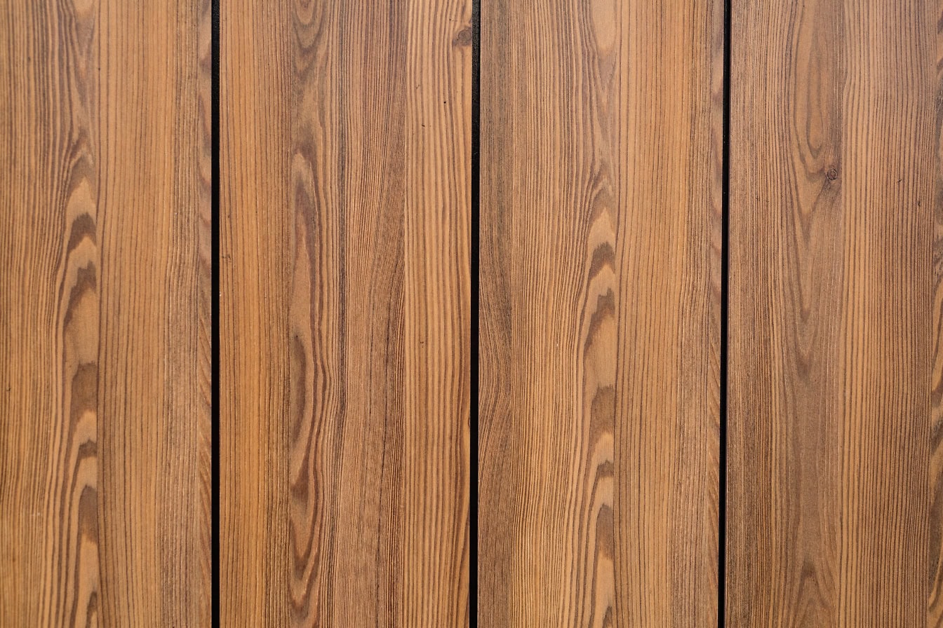 Texture of a light brown wood panel with vertical hardwood planks