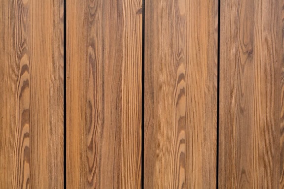 Texture of a light brown wood panel with vertical hardwood planks