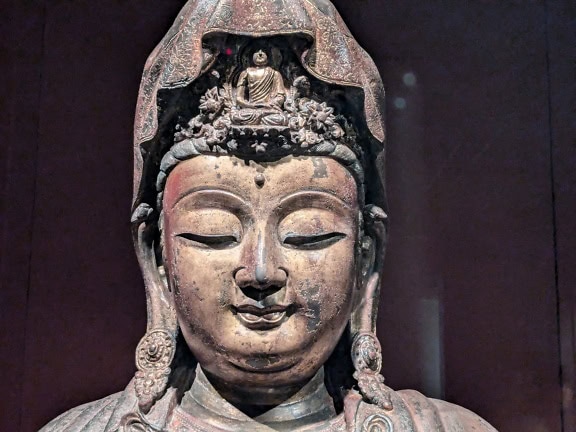 A Buddha statue with a headdress, an ancient artifact in the National Palace Museum in Taipei, Taiwan