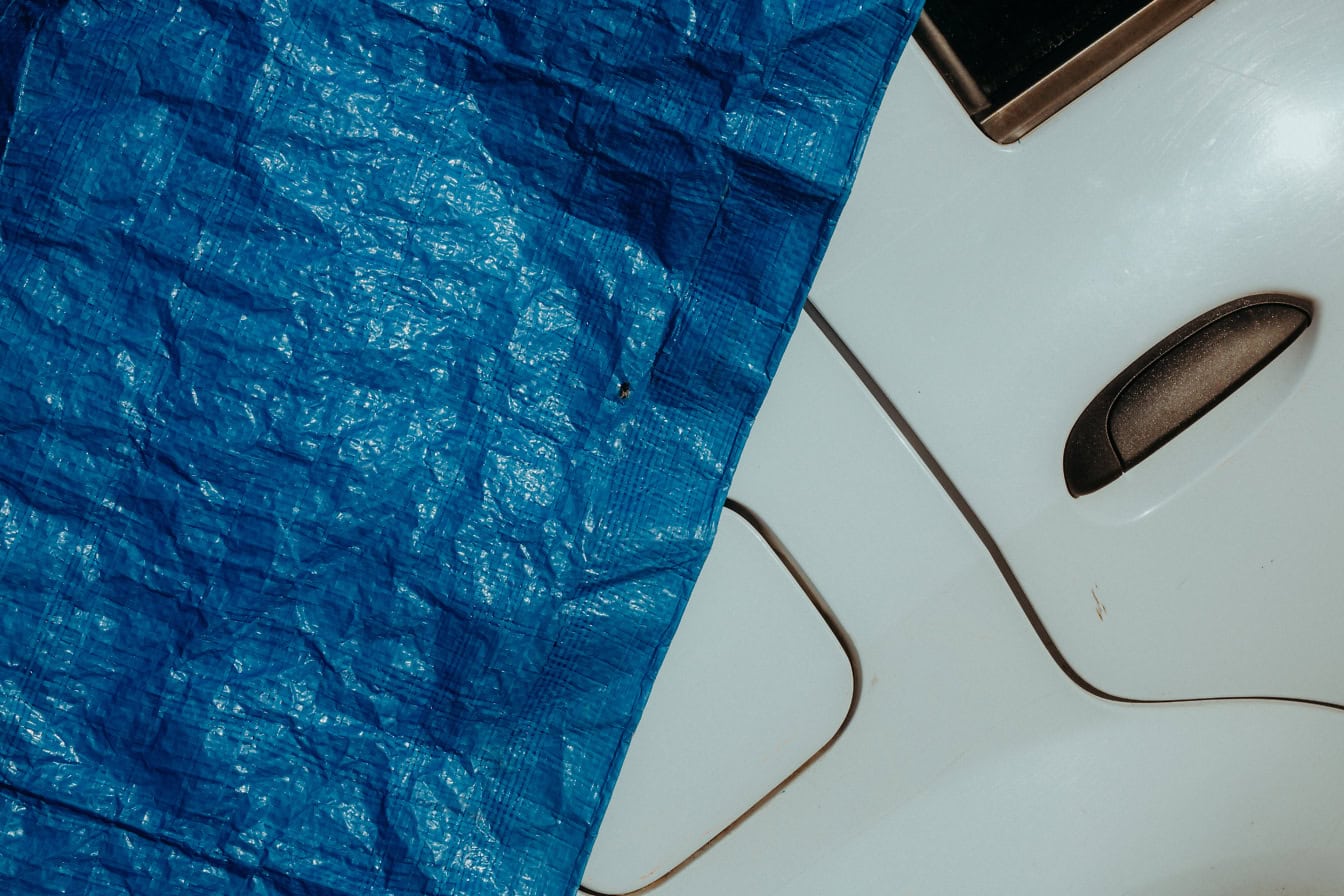 Dark blue industrial tarpaulin on a white metal surface