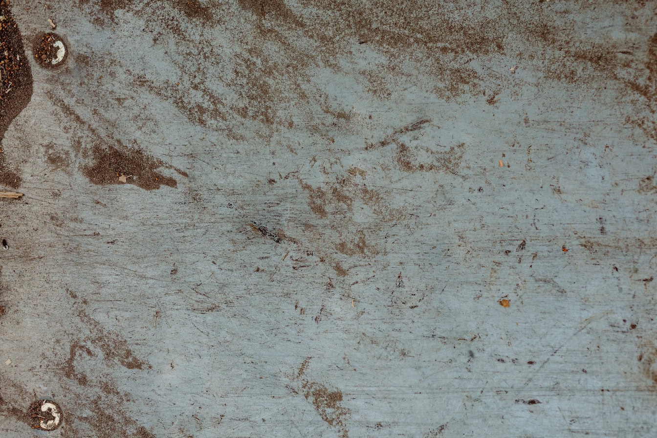 Texture d’une surface en bois sale avec de la poussière brune et des boulons métalliques