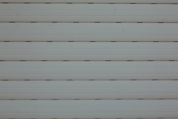 A close-up texture of a white plastic window blinds with horizontal lines