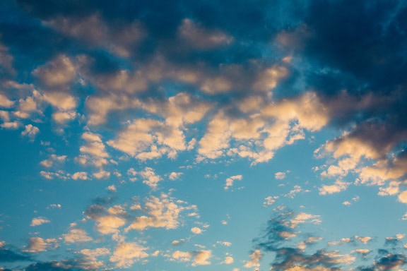 Landscape photograph of a dark grey clouds in the blue sky