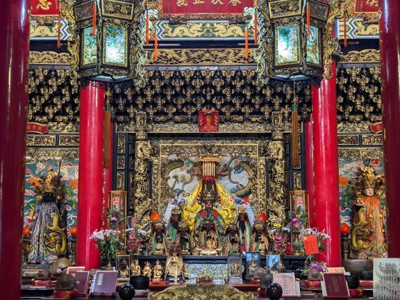 The shrine of the Taoist Buddhist temple with red columns in Chinatown, Taiwan