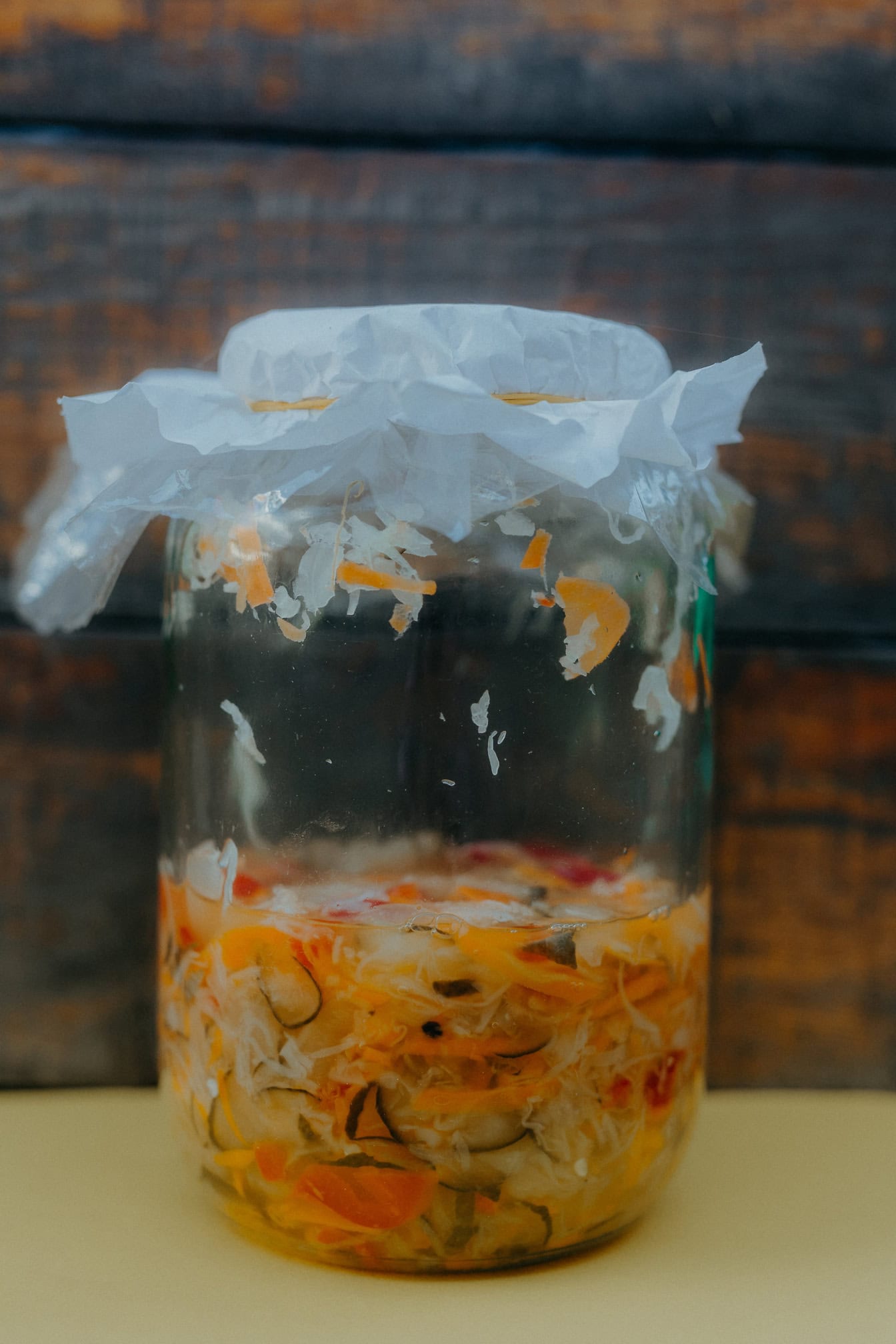 A jar of homemade salad, a close-up of a half-full glass jar with food in it