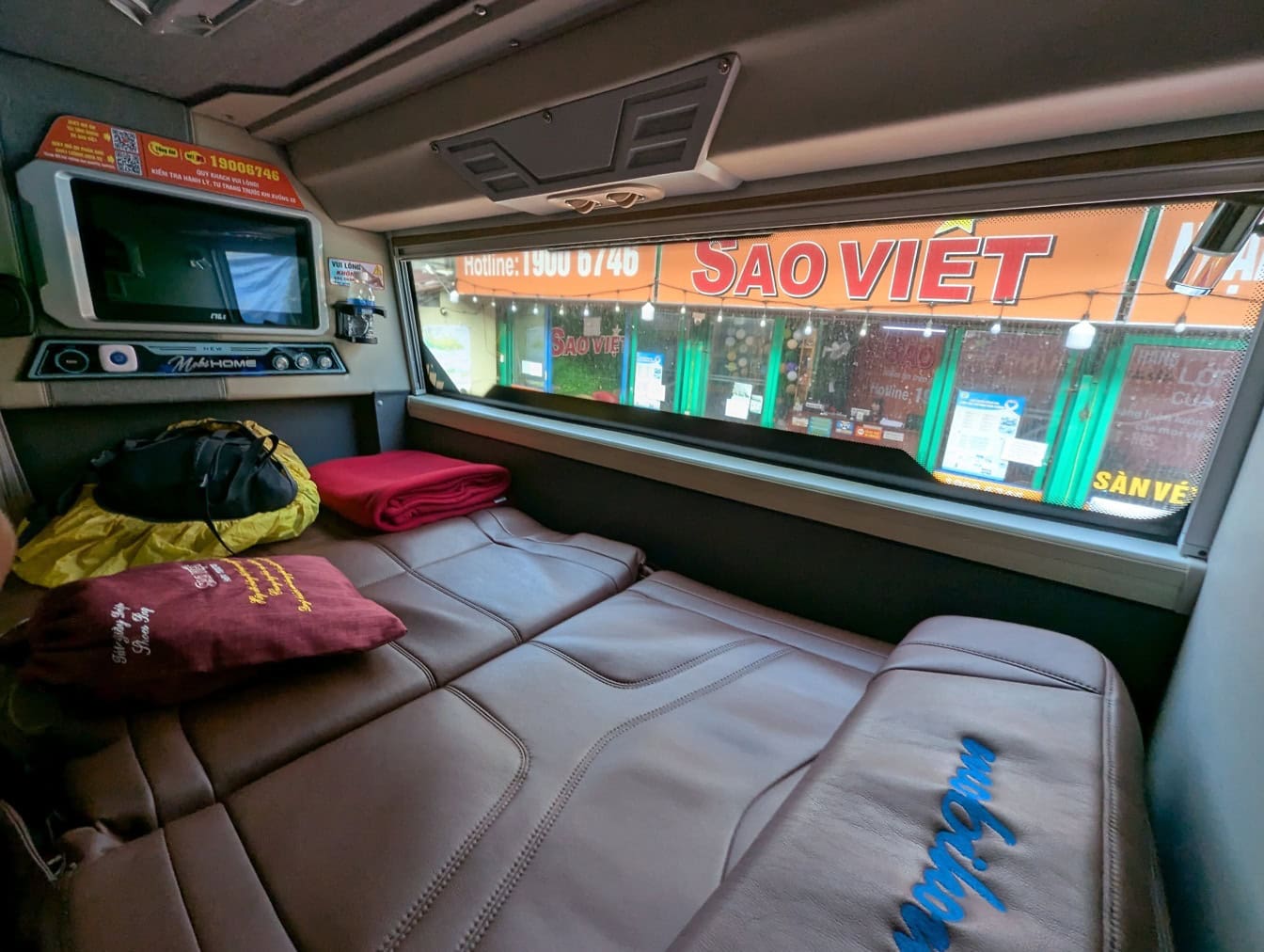 The cabin inside a vehicle with a bed, a modern accommodation interior of the Sao Viet sleeping bus with TV, Socialist Republic of Vietnam