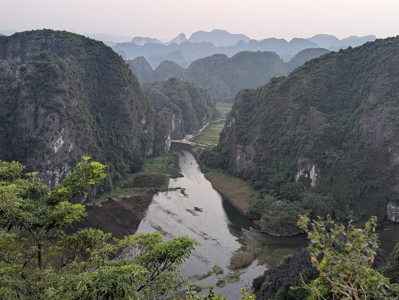 Aerial view o the northern Vietnam and the Ninh Binh river in valley between mountains with trees