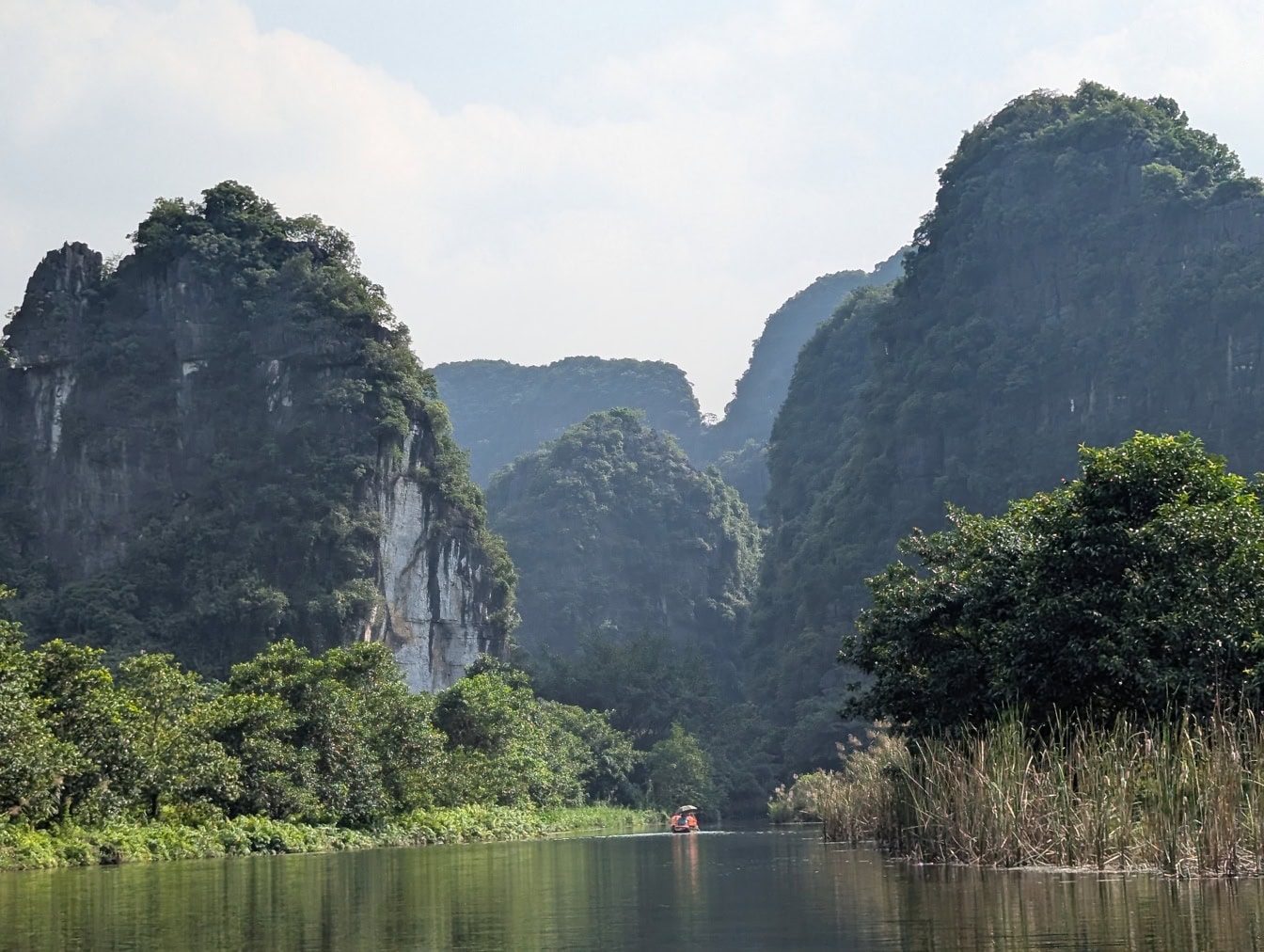 The Ninh Binh river in valley with trees and mountains, northern Vietnam