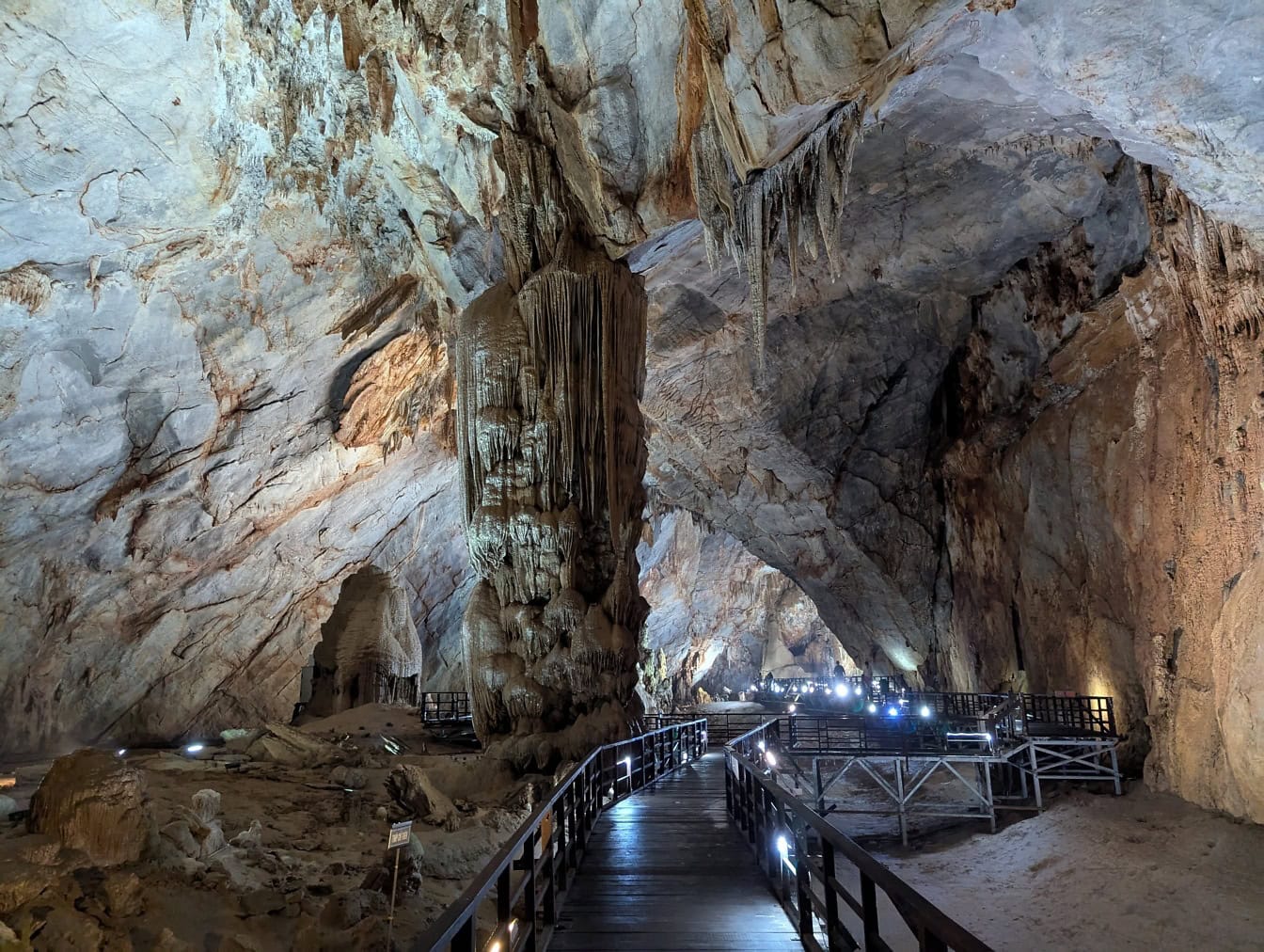 Walkway in a cave around natural column made out of stalactite and stalagmite