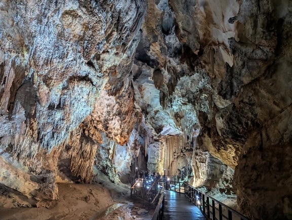 Walkway in a cave underneath stalactites, underground natural park in Vietnam