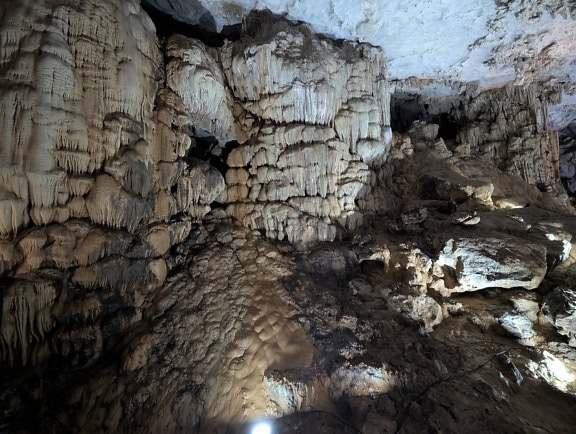 A cave with massive stalactites and stalagmites, a natural mineral formation that takes a long period to form