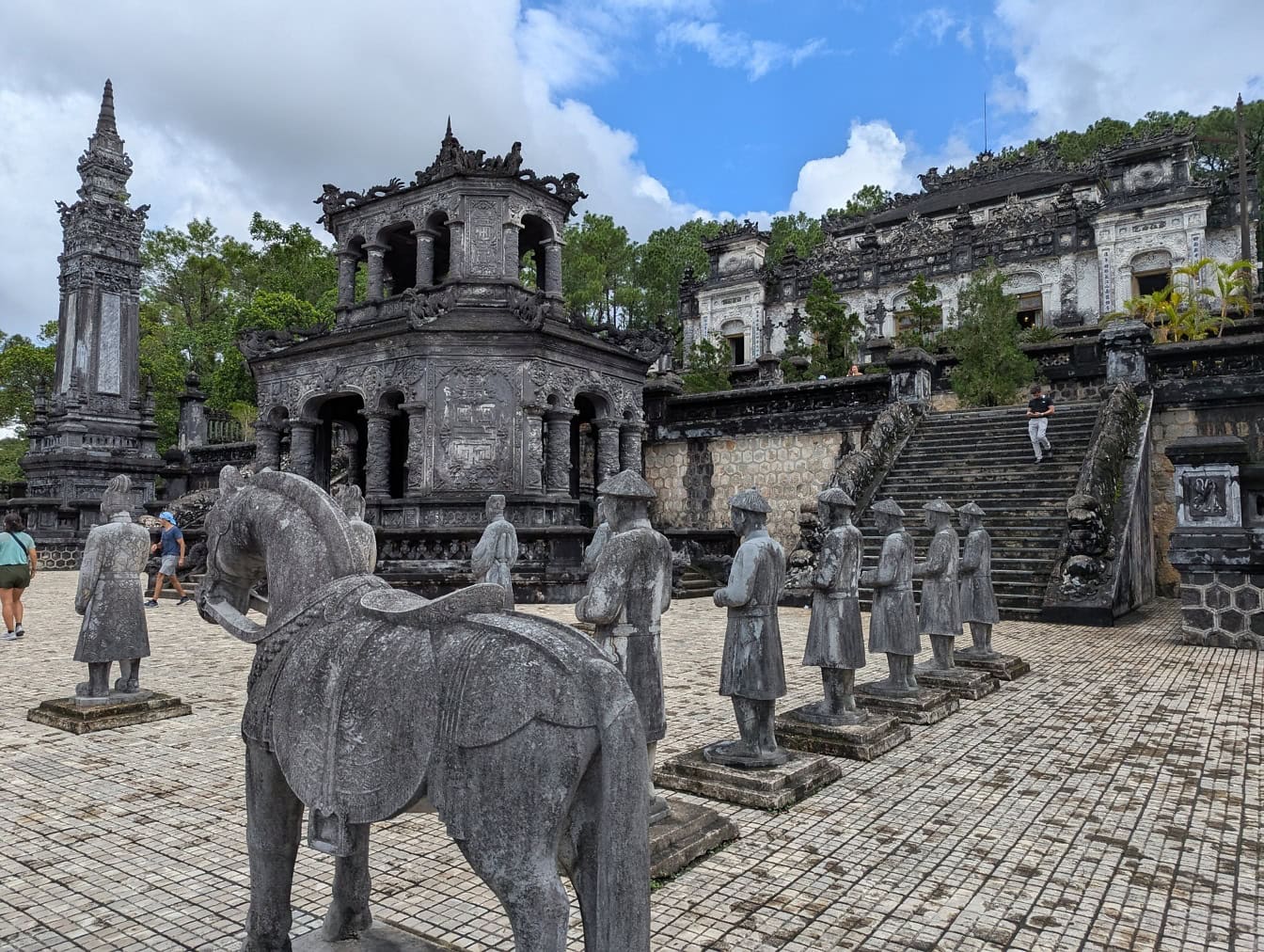 Stone statues of horse and Buddhist monks in a courtyard at imperial mausoleum and Khai Dinh tomb, Nguygen dynasty, Vietnam