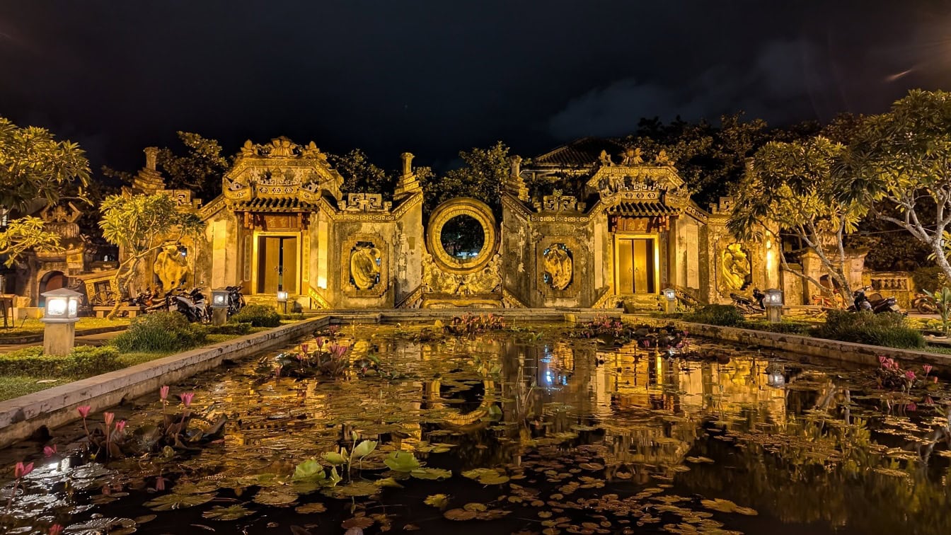 A gate of the Ba Mu temple at night, rich cultural and historical heritage in a city of Hoi An, a spiritual and tourist site in Vietnam