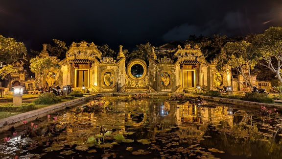 A gate of the Ba Mu temple at night, rich cultural and historical heritage in a city of Hoi An, a spiritual and tourist site in Vietnam