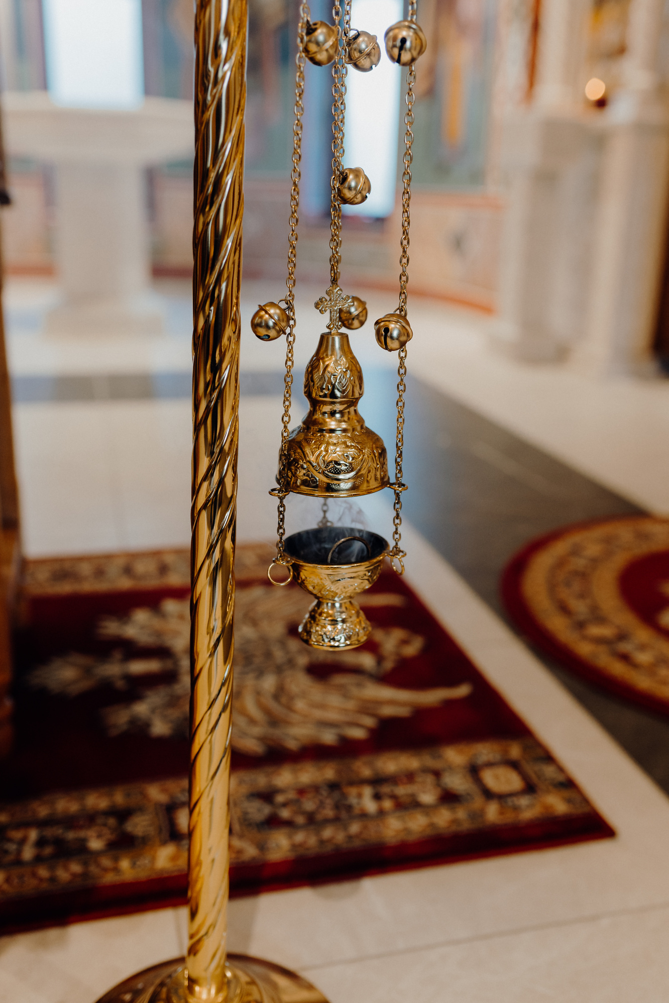 A shiny gold plated object an ecclesiastical censer with incense, a sacral and spiritual item in Christianity used in a religious liturgy