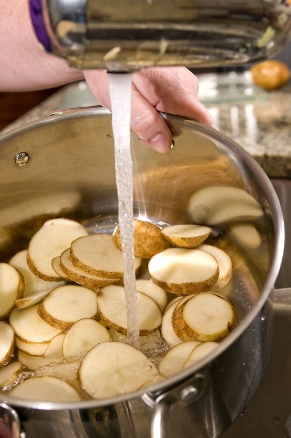fresh, sliced, white potato, slices, contained, stainless, steel, cooking, pot