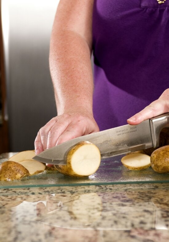 preparing, washed, white potatoes, glass cutting board