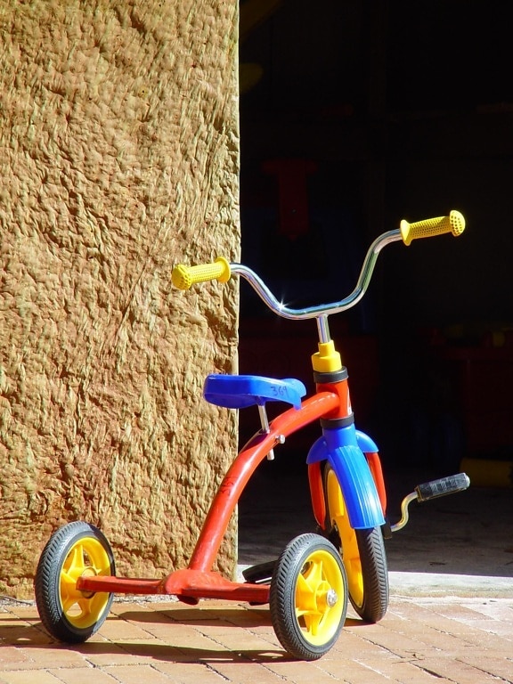 child, tricycle, red, blue, yellow