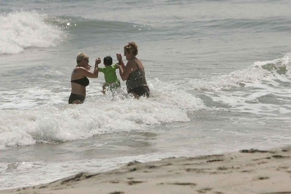 family enjoying, dip, ocean