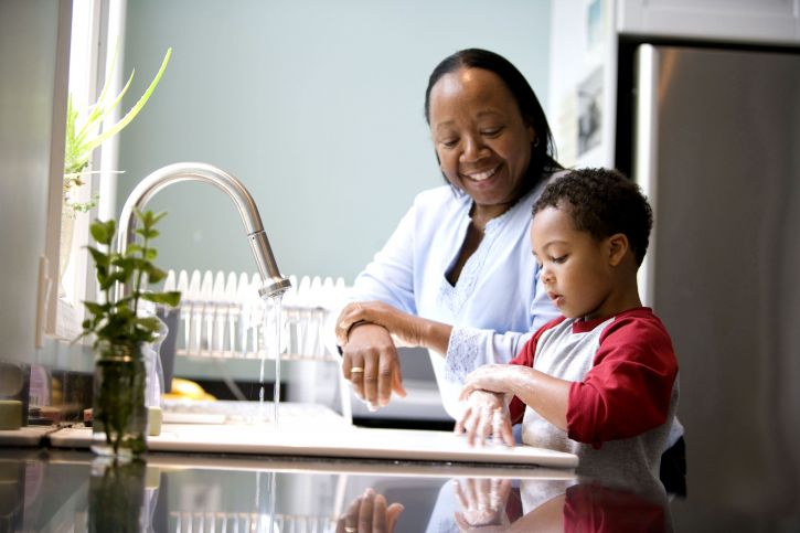 A mother helping her son wash his hands.^[[Image](https://pixnio.com/people/boy-enjoys-the-washing-of-hands-with-his-mother) is in the public domain]