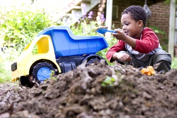 African American, cute, young boy, play, toys, backyard, dirt, pile