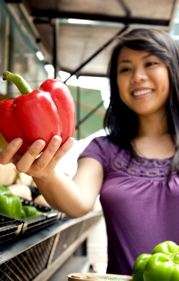 Asian, woman, picking, bright red, ripe, bell pepper, plastic, basket, container, market