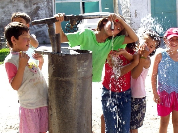 children, play, water pump, Kazakhstan