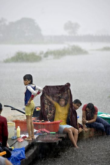 children, wash, clothes, torrential, downpour, Trinidad, flooded, area