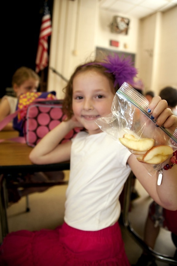 girl, holding, plastic, bag, hand, contained, apple, slices