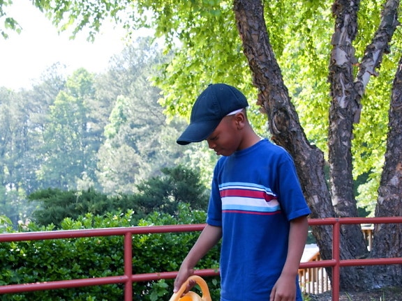 young, African American, school boy, watering
