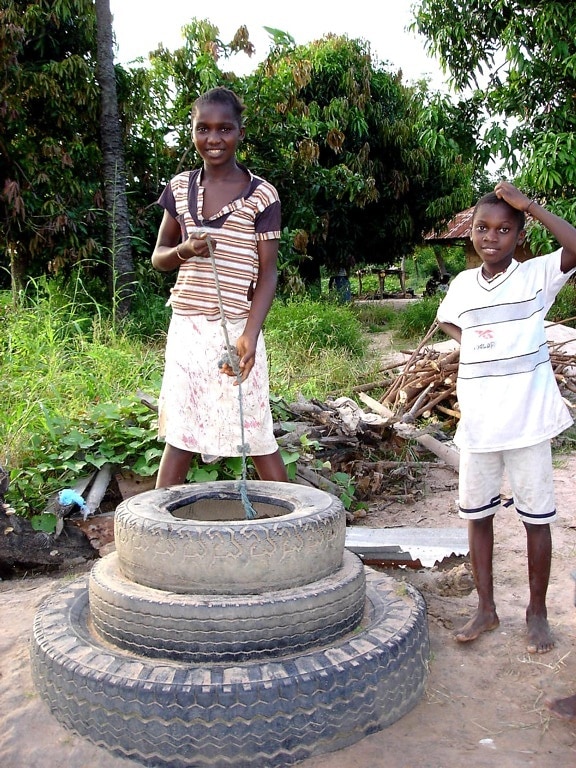 young boy, girl, Africa, collecting, water, uncovered, well