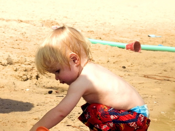 young boy, beach, toys
