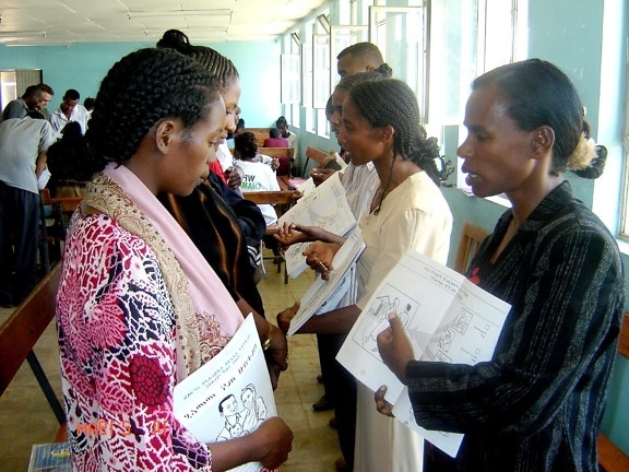 volunteer, workers, Ethiopia, explains, contents, family, health, card, volunteer