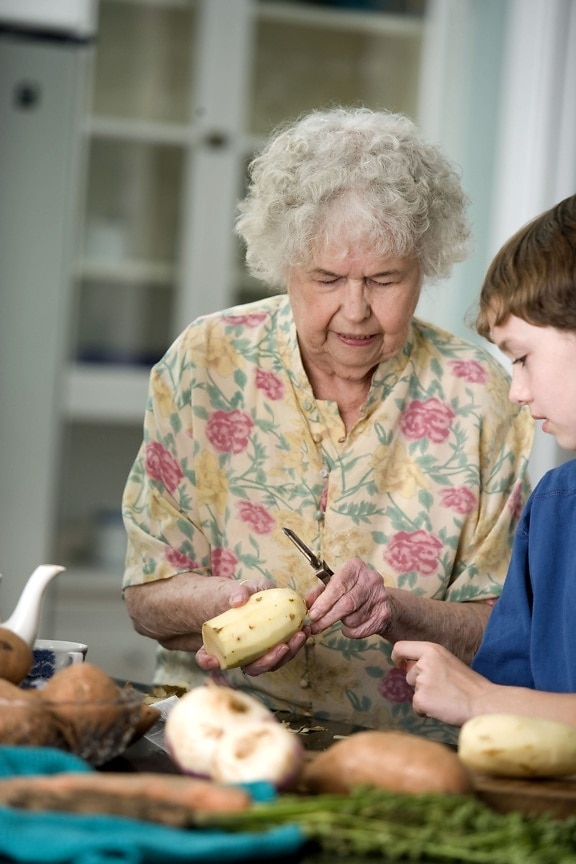 elderly, woman, teaching, grandson, peel, sweet, potatoes