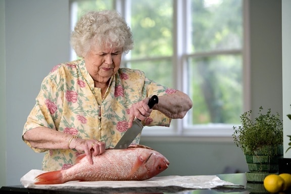 caucAsian, woman, filleting, fish, clean, kitchen, counter