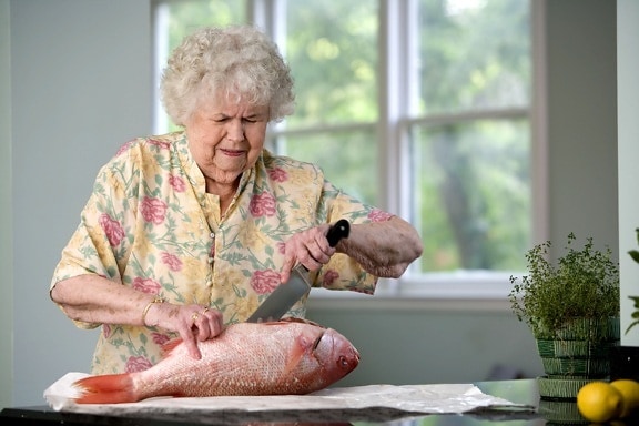 elderly, CaucAsian, woman, process, food, preparation, filleting, fresh, fish