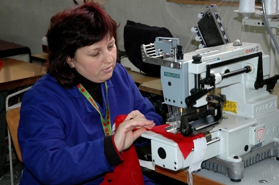 female, worker, demonstrates, stitch, sewing machine