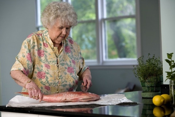 gutted fish, large knife, woman, food