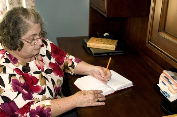 older woman, writing, book