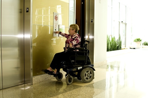 woman, wheelchair, pressing, easily, reachable, button