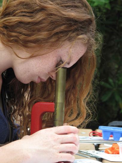 young female, apprentice, looking, microscope