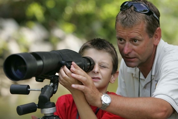 father, helps, son, focus, spotting, scope, closer, look