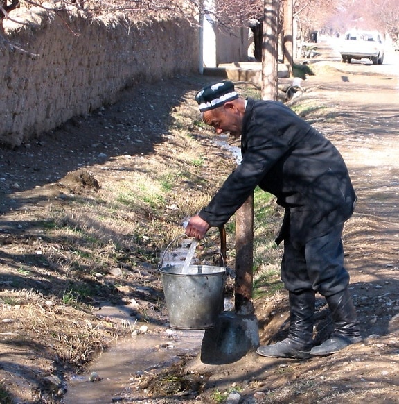 navobod, abitante del villaggio, raccoglie, pompa dell'acqua, passi, casa