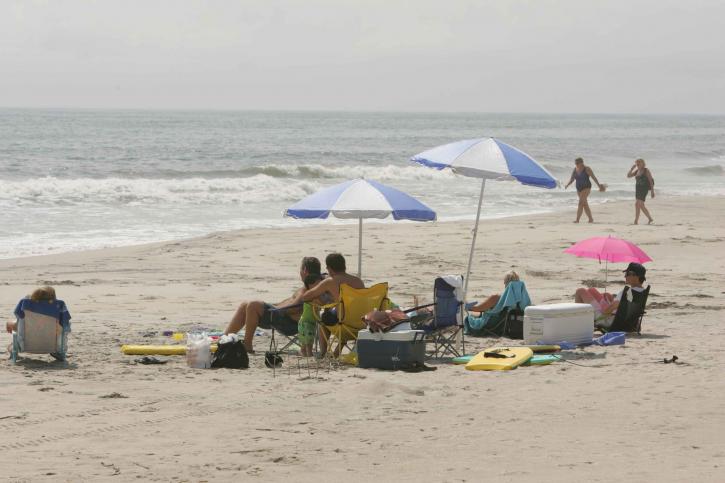 people sunbathing, beach, parasols